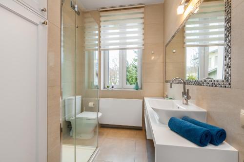 ein Badezimmer mit einem Waschbecken, einer Badewanne und einer Dusche in der Unterkunft Apartamenty Black&White - Apartament Royal - free parking in Sopot