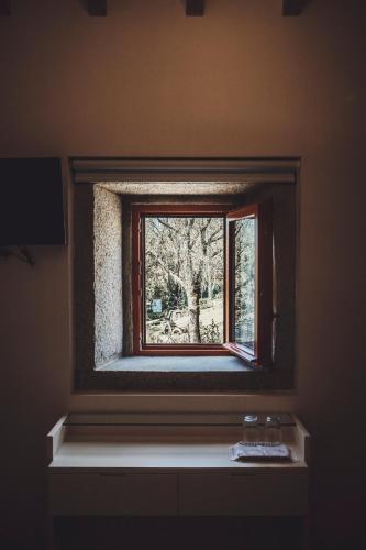 a window on a wall in a room at Azenha do Tio Luís in Caminha