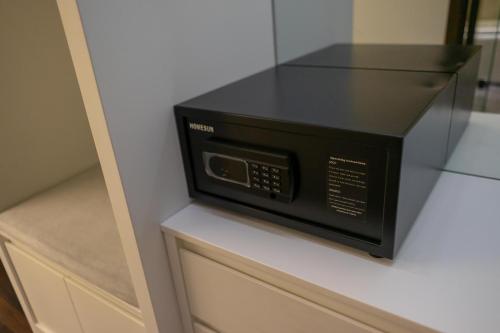 a microwave oven sitting on top of a cabinet at KP Hotel in Can Tho
