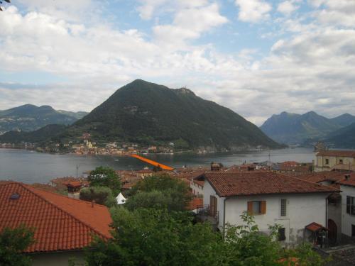 a view of a town with a lake and mountains at Uliveto in Sulzano