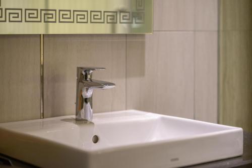 a white sink with a faucet in a bathroom at KP Hotel in Can Tho