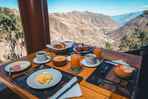 a table with plates of food on a table with a view at Refugio Viñak in Viñak