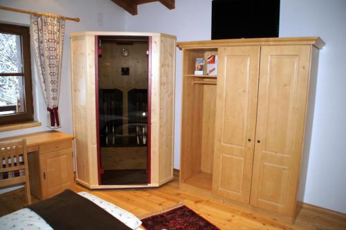 a room with a large wooden cabinet in a room at Gasthaus Goglhof in Fügenberg