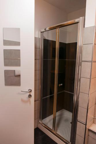 a shower with a glass door in a bathroom at Villino Erminia - Seaside Art b&b in Pizzo