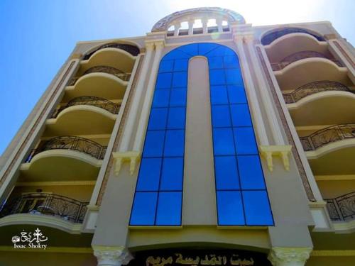 a large building with blue glass windows on it at St. Marie House in Asyut