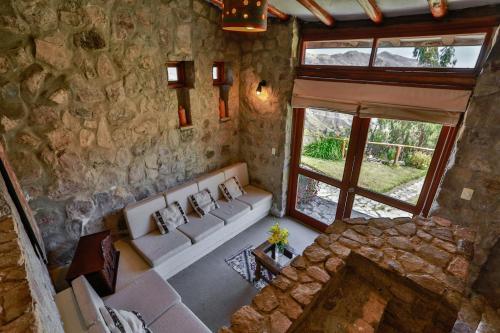 an overhead view of a living room with a stone wall at Refugio Viñak in Viñak