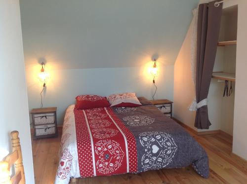 ein Schlafzimmer mit einem Bett mit zwei Lampen an der Wand in der Unterkunft les gites les trois chemins in Pavilly