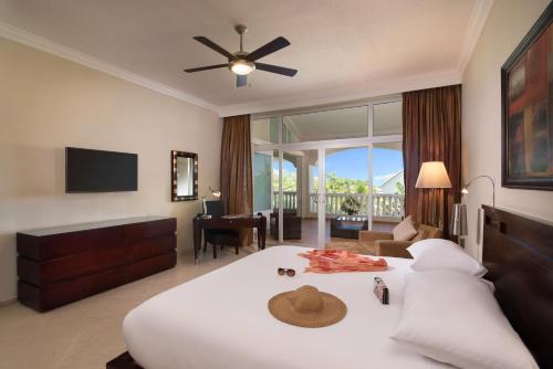 1 dormitorio con 1 cama con sombrero en Presidential Suites by Lifestyle Puerto Plata - All Inclusive en San Felipe de Puerto Plata