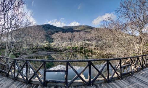a bridge over a river with a mountain in the background at Antartisa B&B in Límni