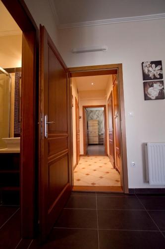 a hallway leading to a room with a door at Centrum Panzió in Mohács