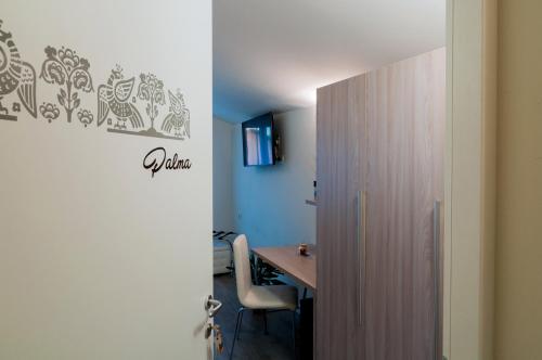 a room with a desk and a table with a chair at VILLA FENIX OSIO SOTTO in Osio Sotto