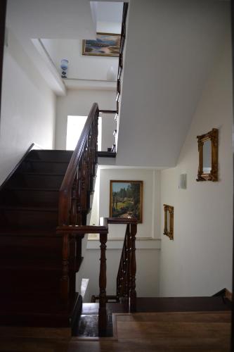 a staircase in a house with a painting on the wall at Casa azul in Gouveia