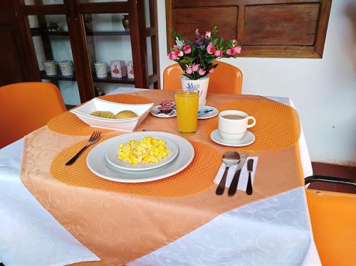 a table with a plate of scrambled eggs on it at Hotel Casa del Marquez de Bahichala in Barichara