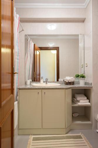 a bathroom with a sink and a large mirror at BARRAMARES 2 in Ovar