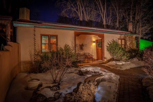 a house with snow in the yard at night at Dreamcatcher B&B in Taos