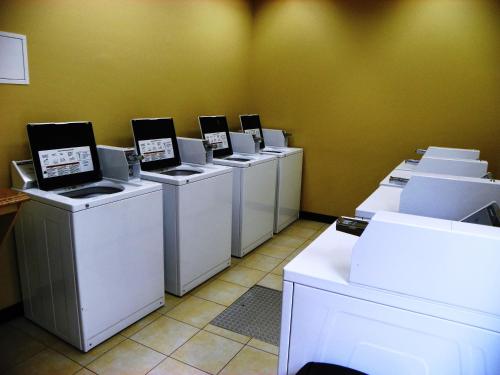 a row of washers and dryers lined up against a wall at Ramada by Wyndham Venice Hotel Venezia in Venice