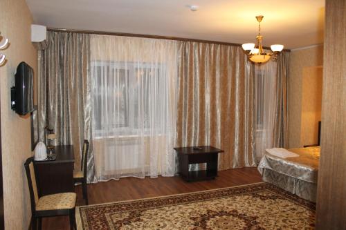 a hotel room with a bed and a window at Sultan Beibarys in Astana