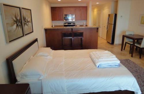 a bedroom with a large white bed in a kitchen at Hotel La Vista Azul in Turtle Cove