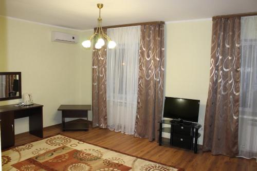 a living room with a television and curtains at Sultan Beibarys in Astana
