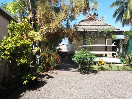 a house with a bench and a gazebo at AU FARE MOENAU in Paea
