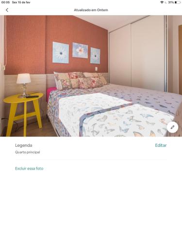 a bedroom with a bed and a yellow table at Amora Três in São Paulo