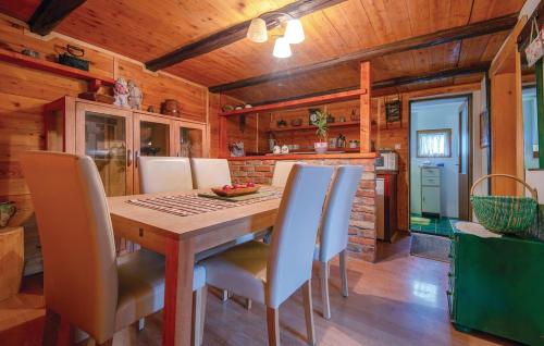 a kitchen and dining room with a wooden table and chairs at Grebengradska Medna Hiža in Donje Makojišće