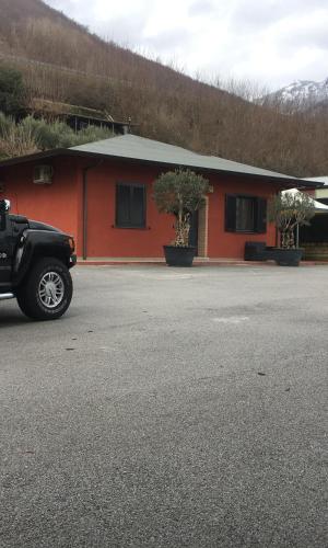 a truck parked in front of a red building at Villa Masullo in Mercogliano