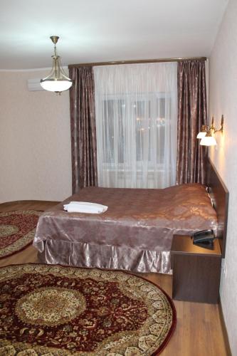 a bedroom with two beds and a window at Sultan Beibarys in Astana