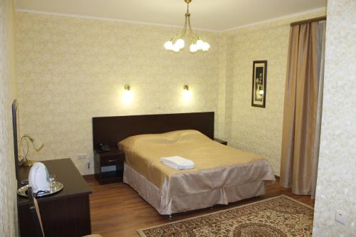 a hotel room with a bed and a telephone at Sultan Beibarys in Astana