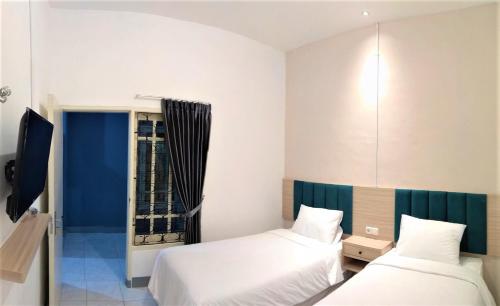 Postel nebo postele na pokoji v ubytování Kokonut Guesthouse