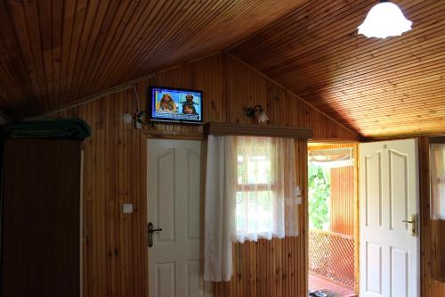Zimmer mit einem TV an der Decke eines Hauses in der Unterkunft Alibaba Pension in Cıralı