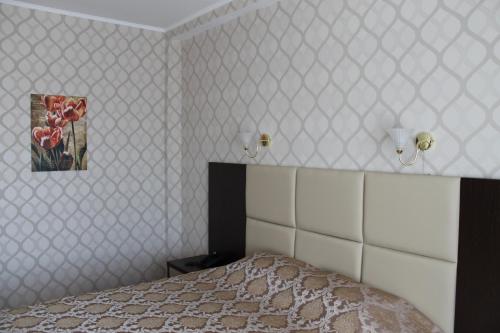 a bedroom with a bed and a picture on the wall at Sultan Beibarys in Astana