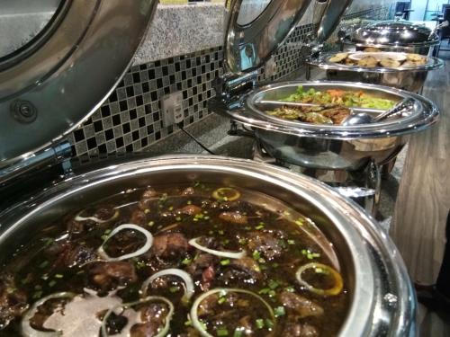 a large pot of food in a restaurant kitchen at Purnama Hotel in Limbang