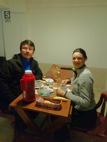 a man and a woman sitting at a table at Catari's House in Machu Picchu