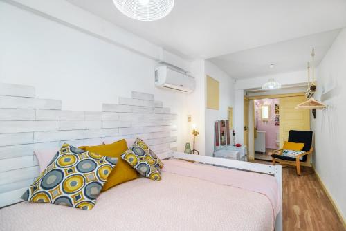 a bedroom with a bed with yellow and blue pillows at Casa Sá Noronha Old Town in Porto