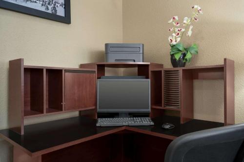 an office with a desk with a computer on it at Super 8 by Wyndham S Jordan/Sandy/Slc Area in South Jordan
