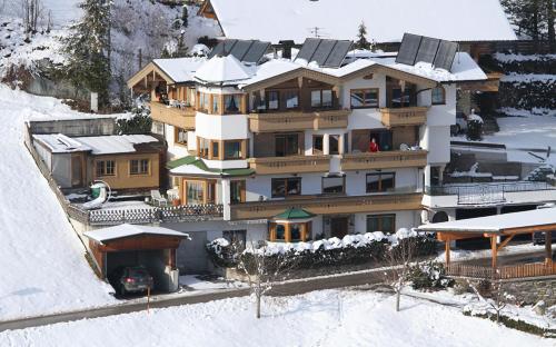 a large house in the snow with snow at Haus am Sonnenhang in Finkenberg