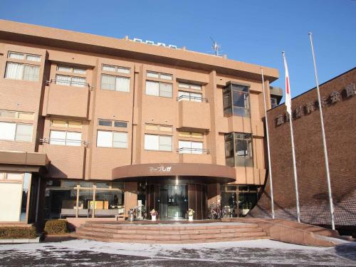 a large brick building with a staircase in front of it at Hotel ab Shiga in Otsu