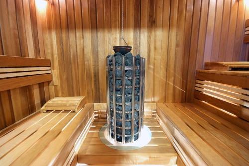 a sauna with a large blue vase in the middle at Vila Moldavia Class in Slănic-Moldova