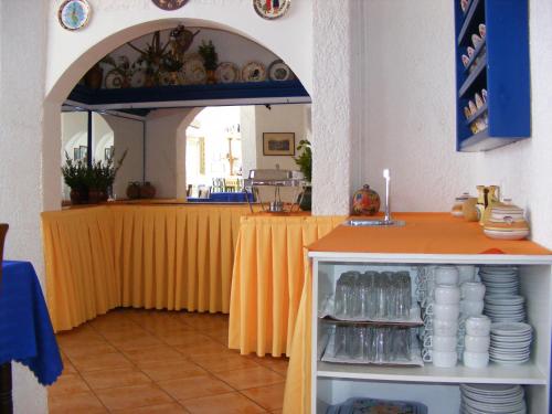 a restaurant with a table with a yellow table cloth at Atlantis Hotel in Karpathos Town