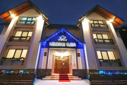 a building with a sign that reads maulding glass at Vila Moldavia Class in Slănic-Moldova