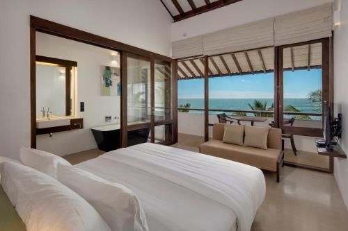 
a hotel room with two beds and a large window at Three Gables Boutique Villa in Mirissa
