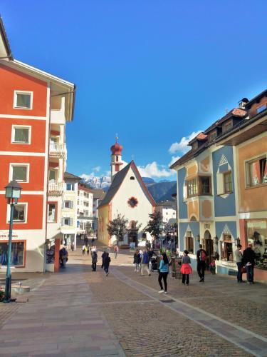 a group of people walking down a street in a town at CESA VEDLA - Alpine Dolomites silent and cozy in Ortisei