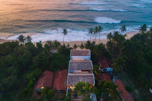 an aerial view of a building on the beach at Three Gables Boutique Villa in Mirissa