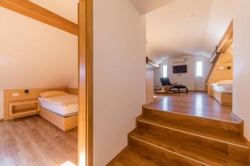 a room with a staircase leading to a bedroom at Kunstelj Pension in Radovljica