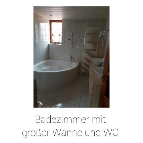 a bathroom with a tub and a sink at Ferienhaus Schäfer in Gerstungen