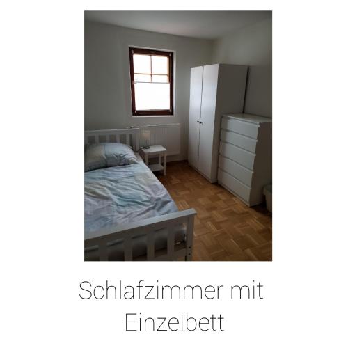 a bedroom with a bed and a dresser at Ferienhaus Schäfer in Gerstungen