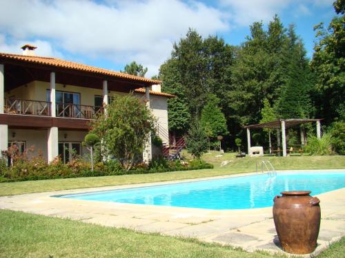 una villa con piscina di fronte a una casa di Casa de Pichoses a Geres