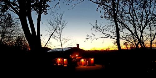 a house with candles in front of a sunset at Bosco Romagno in Cividale del Friuli