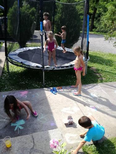 a group of children playing on a trampoline at By the River Hotel Complex in Balkanets